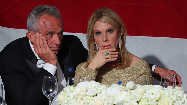 Robert F. Kennedy Jr. and his wife Cheryl Hines sit uncomfortably at the Alfred E. Smith Memorial Dinner in 2024.