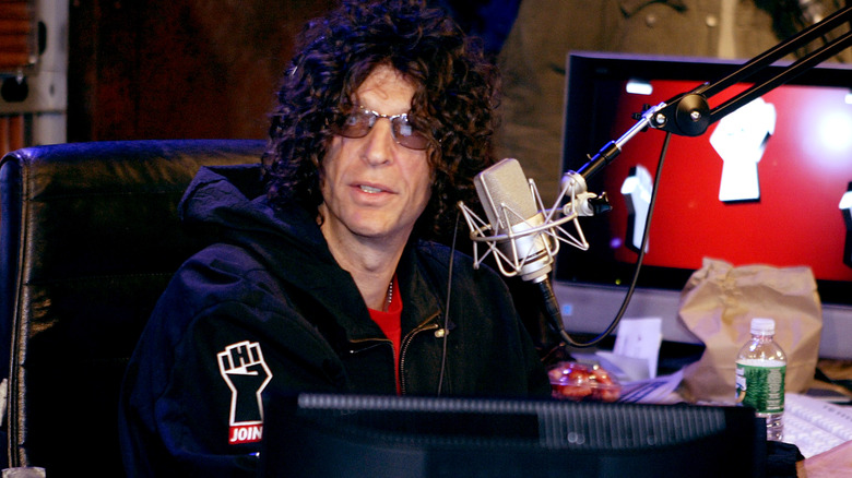 Howard Stern sitting in front of his microphone