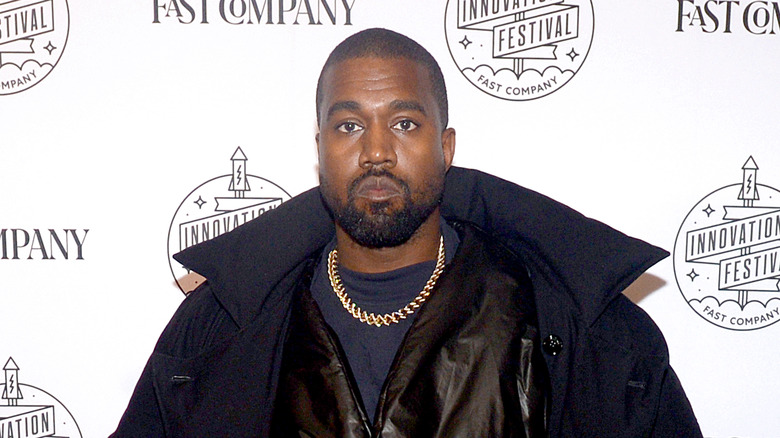 Kanye West posing at an event