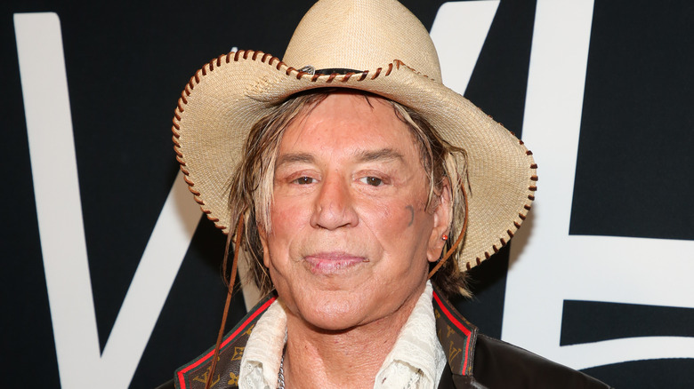 Mickey Rourke posing in straw cowboy hat