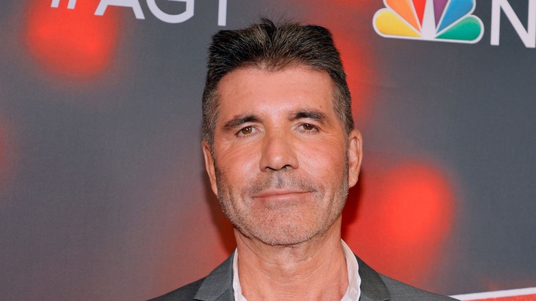 Simon Cowell posing at an NBC event