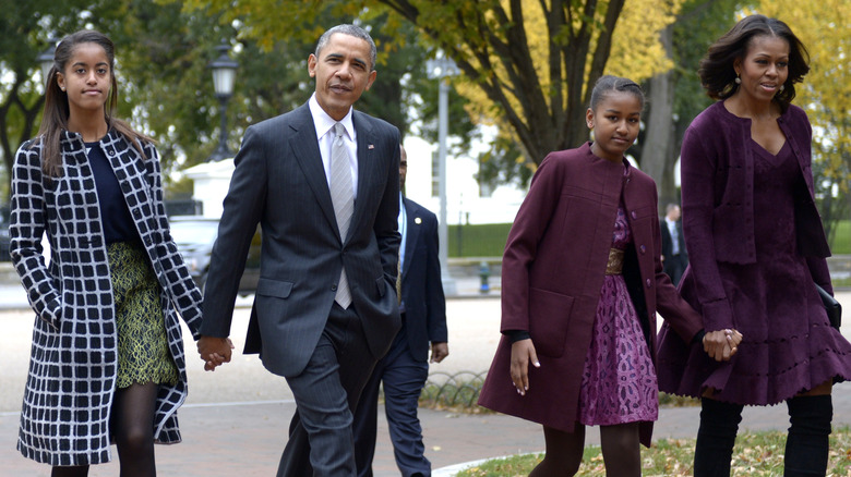 Malia, Barack, Sasha, and Michelle Obama waling together