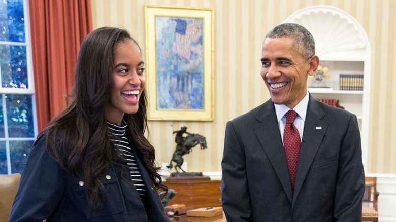 Malia and Barack Obama laughing in Oval Office