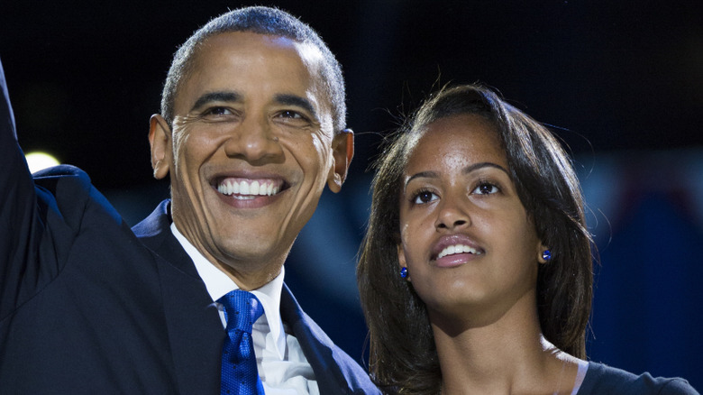 Barack Obama smiling beside Malia