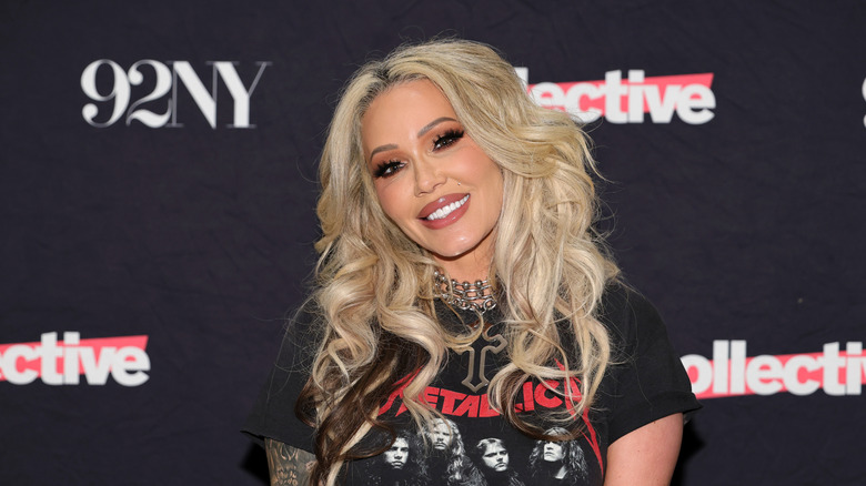 Bunnie Xo smiling big while posing at an event