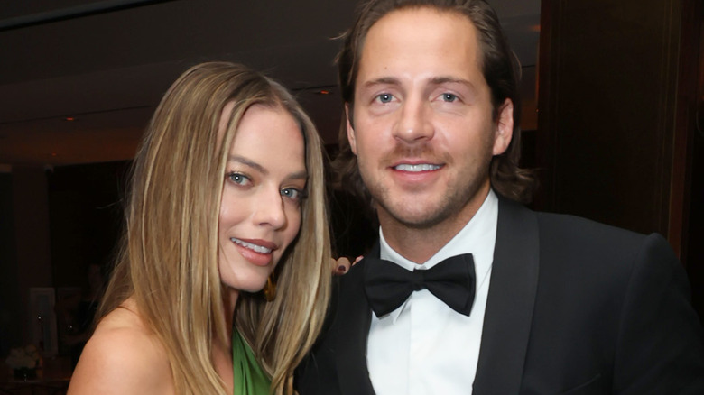 Margot Robbie and Tom Ackerley smiling