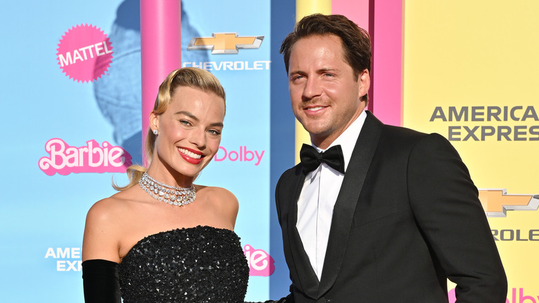 Margot Robbie and Tom Ackerley posing