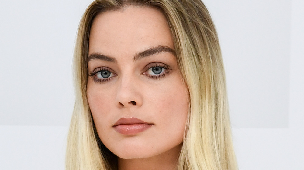 Margot Robbie poses at an event