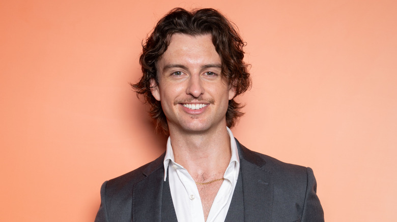 Cameron Robbie wearing gray suit