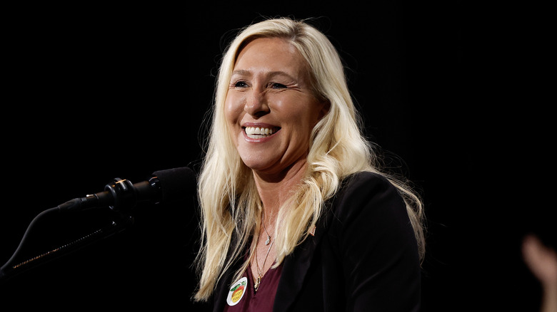 Marjorie Taylor Greene smiling with microphone
