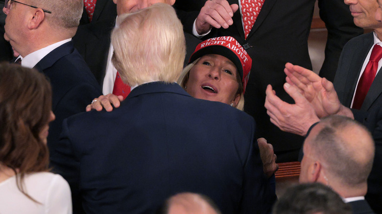 Marjorie Taylor Greene embracing Donald Trump.