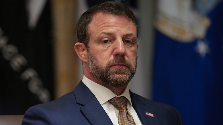 Markwayne Mullin looking downcast in a Cabinet meeting in a dark blue suit