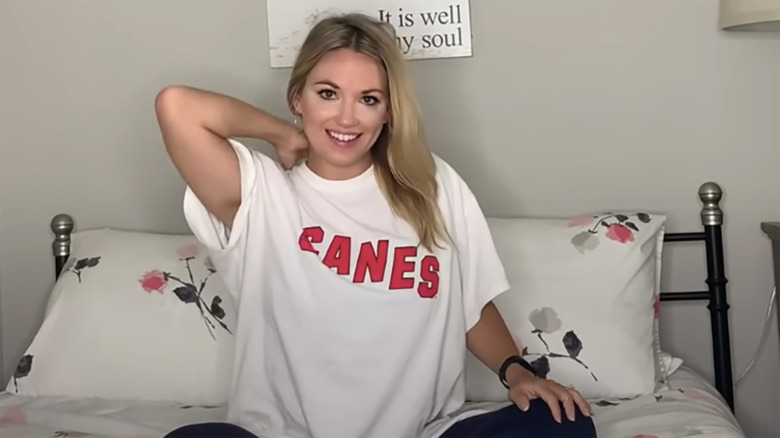 Cortney Hendrix smiling in bedroom while filming video