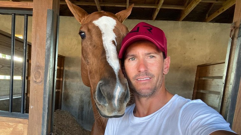 Nic Roldan takes a selfie with a horse