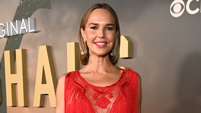 Arielle Kebbel poses in a red lace dress