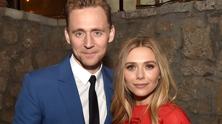 Elizabeth Olsen and Tom Hiddleston smiling