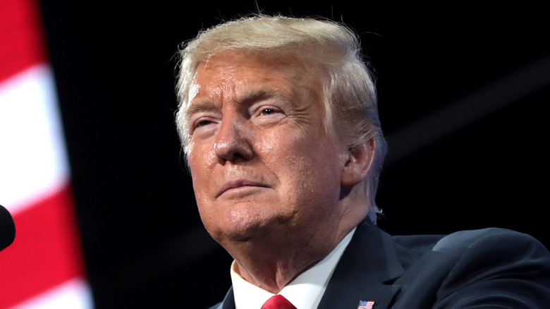 Donald Trump with slight smile speaking at event