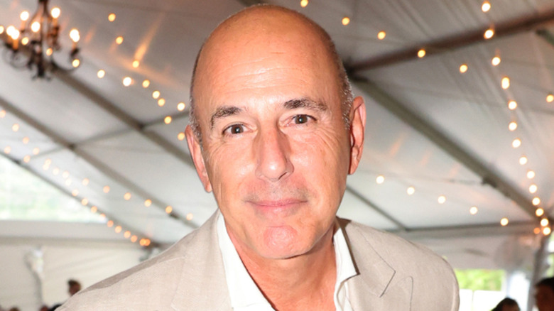 Matt Lauer smiling at the camera in a beige suit