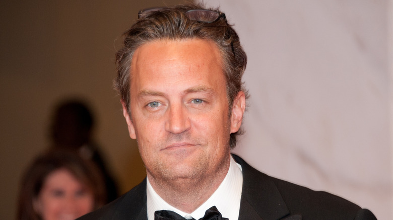 Matthew Perry smiling in tuxedo