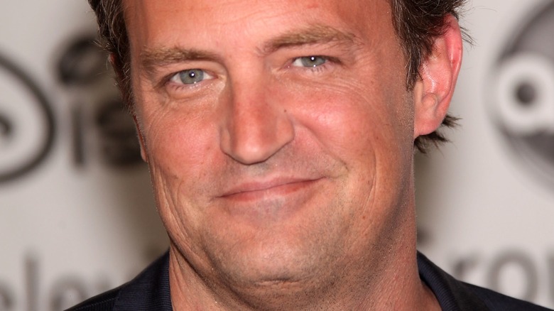 Matthew Perry with a sly smile