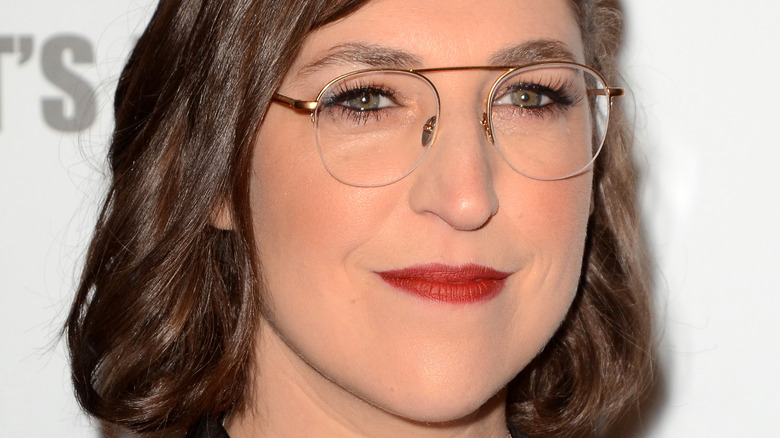 Mayim Bialik in glasses and red lipstick 