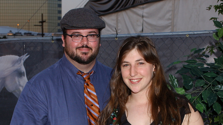 Mayim Bialik posing outdoors with her ex-husband, Michael.