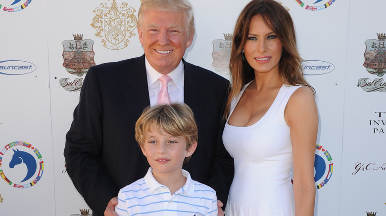 Donald, Melania, and Barron Trump on a red carpet in 2013