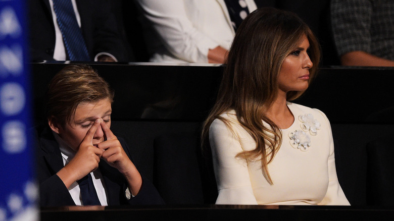 Barron Trump rubs his eyes at the 2016 RNC while sitting next to Melania Trump