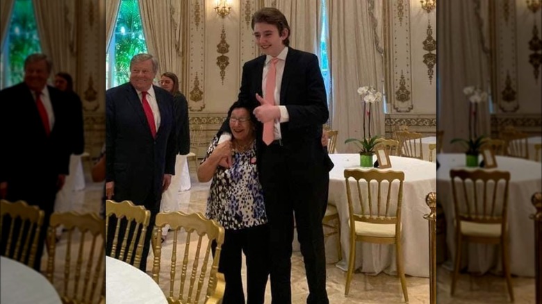 Barron Trump towers over a woman at Mar-a-Lago