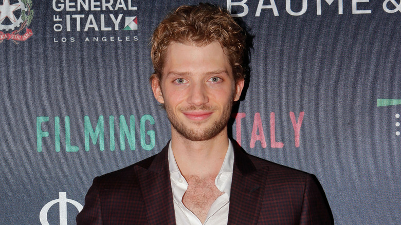 Zack Peck posing at a premiere.