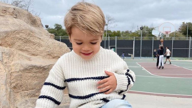 Liam Tell sitting on a rock