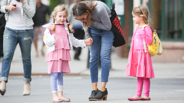 Sarah Jessica Parker leaning down with daughters