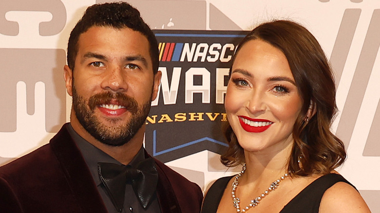Bubba Wallace and Amanda Wallace smiling in formal wear for the press before a Nascar awards ceremony