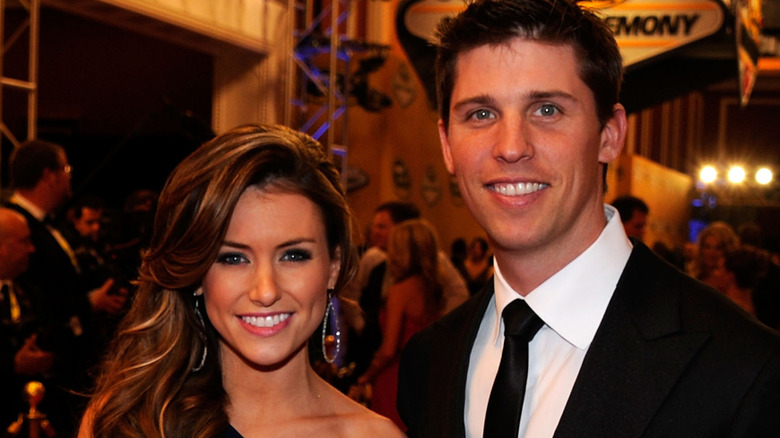 Denny Hamlin and Jordan Fish standing together and smiling for photographers