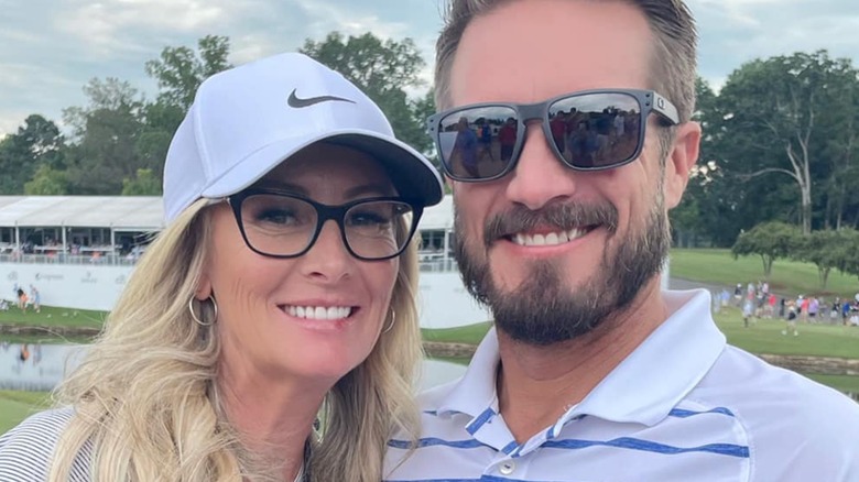 Kristen Marie Yeley and J.J. Yeley smiling by one another outside