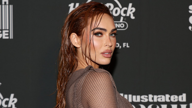 Megan Fox with long red hair styled with a wet look