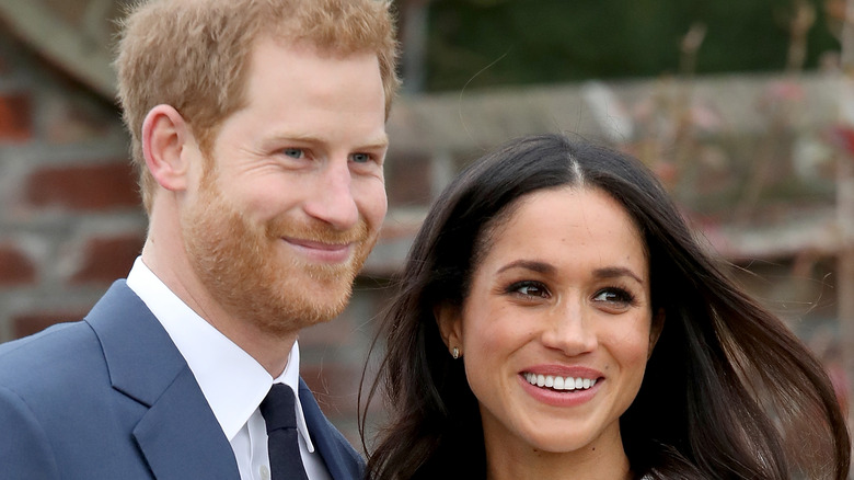Meghan Markle and Prince Harry smile for photo