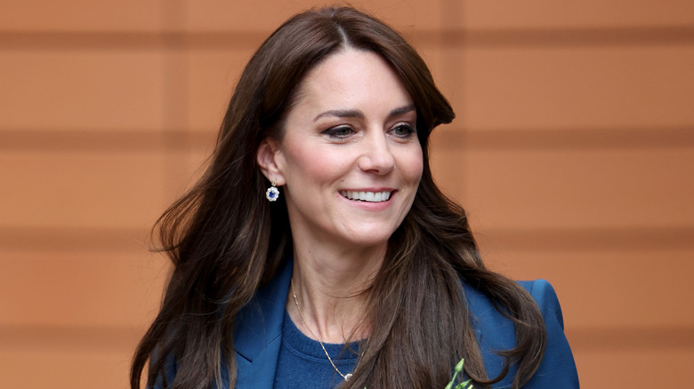 Kate Middleton smiling in blue suit