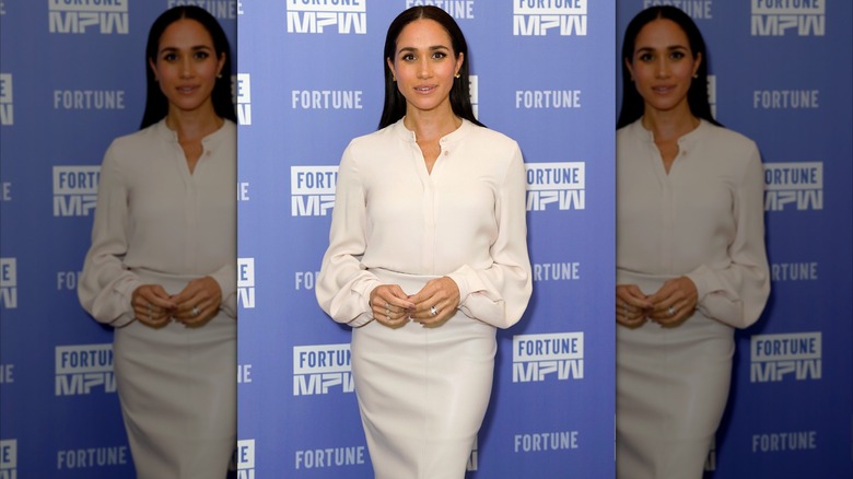 Meghan Markle posing in a white set