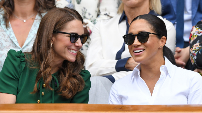 Kate Middleton and Meghan Markle talking