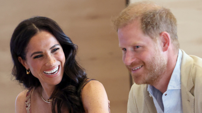Meghan Markle smiling with Prince Harry