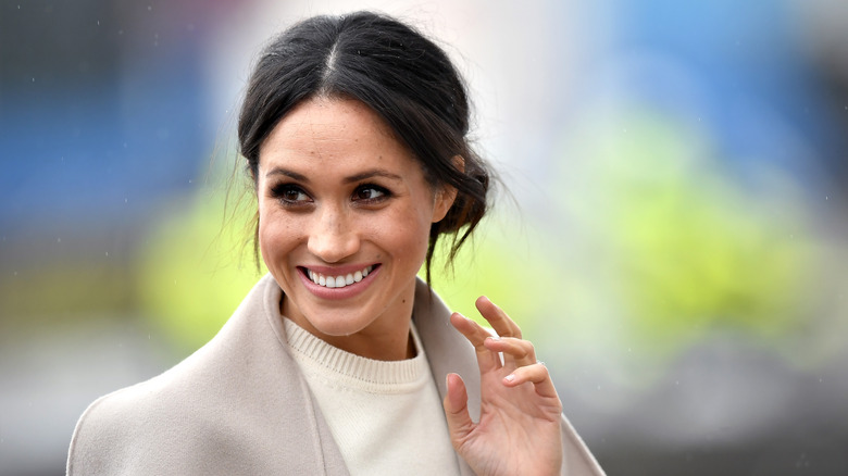 Meghan Markle waving and smiling