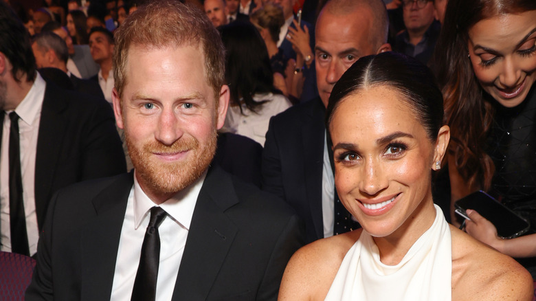 Meghan Markle and Prince Harry smiling at an event