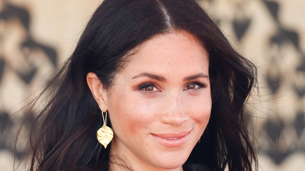 Meghan Markle smiling at an event