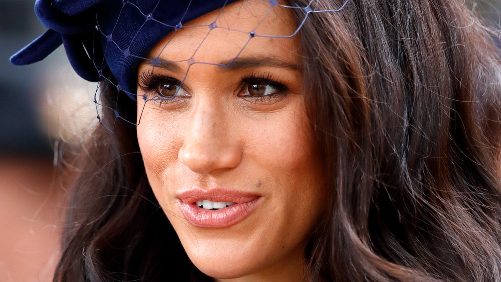 Meghan Markle smiling in hat