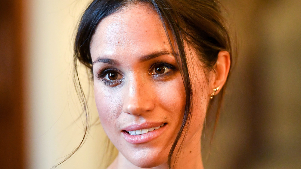 Meghan Markle smiling at an event