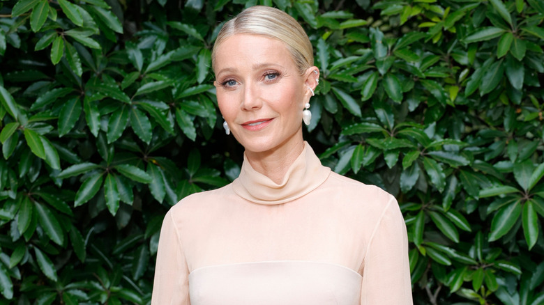 Gwyneth Paltrow posing in front of leaves