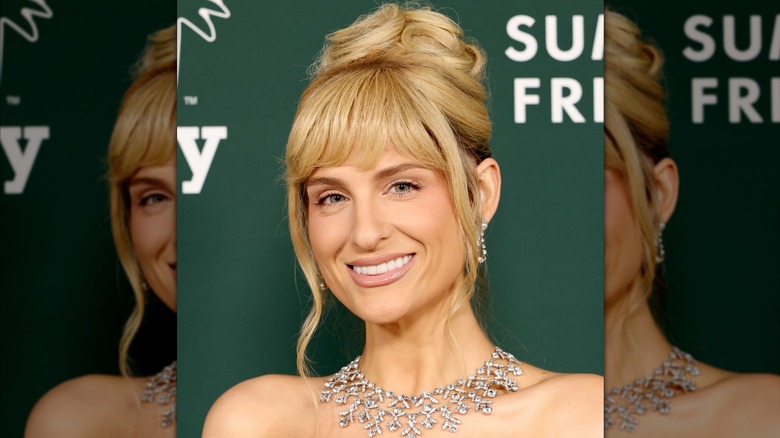 Meghan Trainor wearing a large diamond necklace with her hair styled in an updo with heavy bangs.