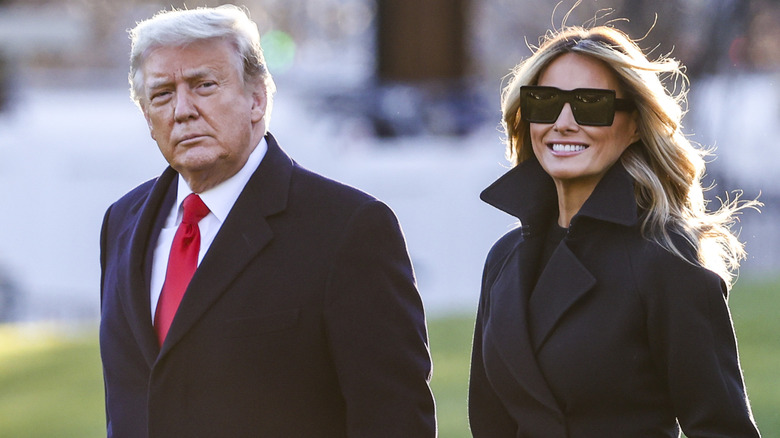 Donald Trump and Melania Trump walking together outdoors