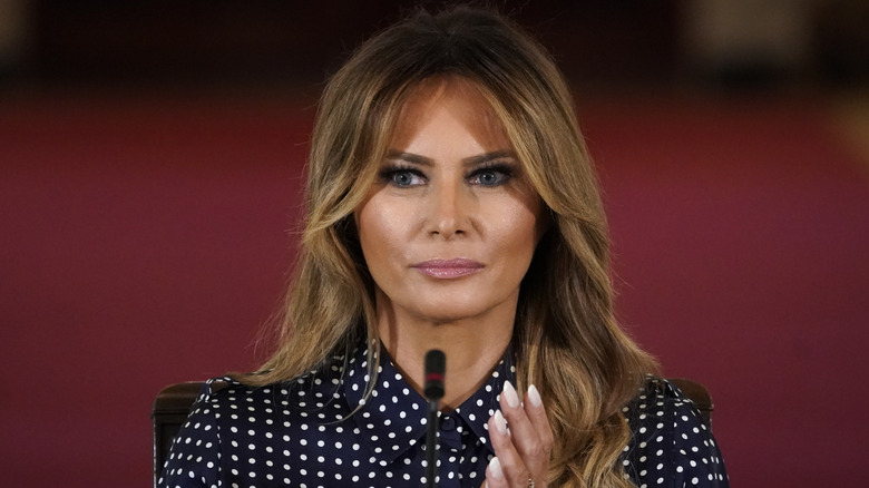 Melania Trump claps while addressing a crowd